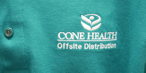 Cone Health logo embroidered on a polo